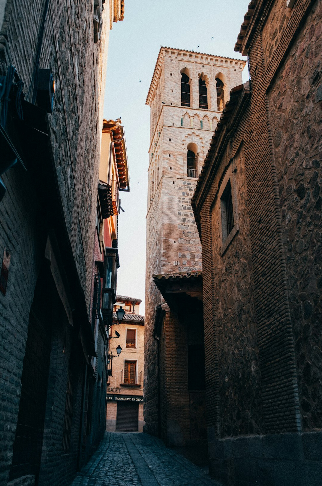 Narrow old town street between tall buildings