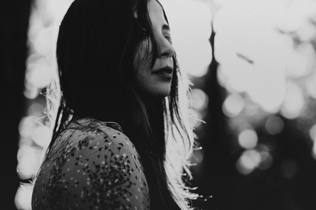 Portrait of a woman with long dark hair smiling